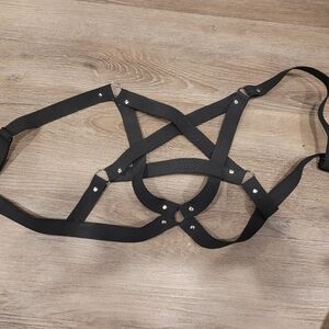 Black pentagram chest harness.
